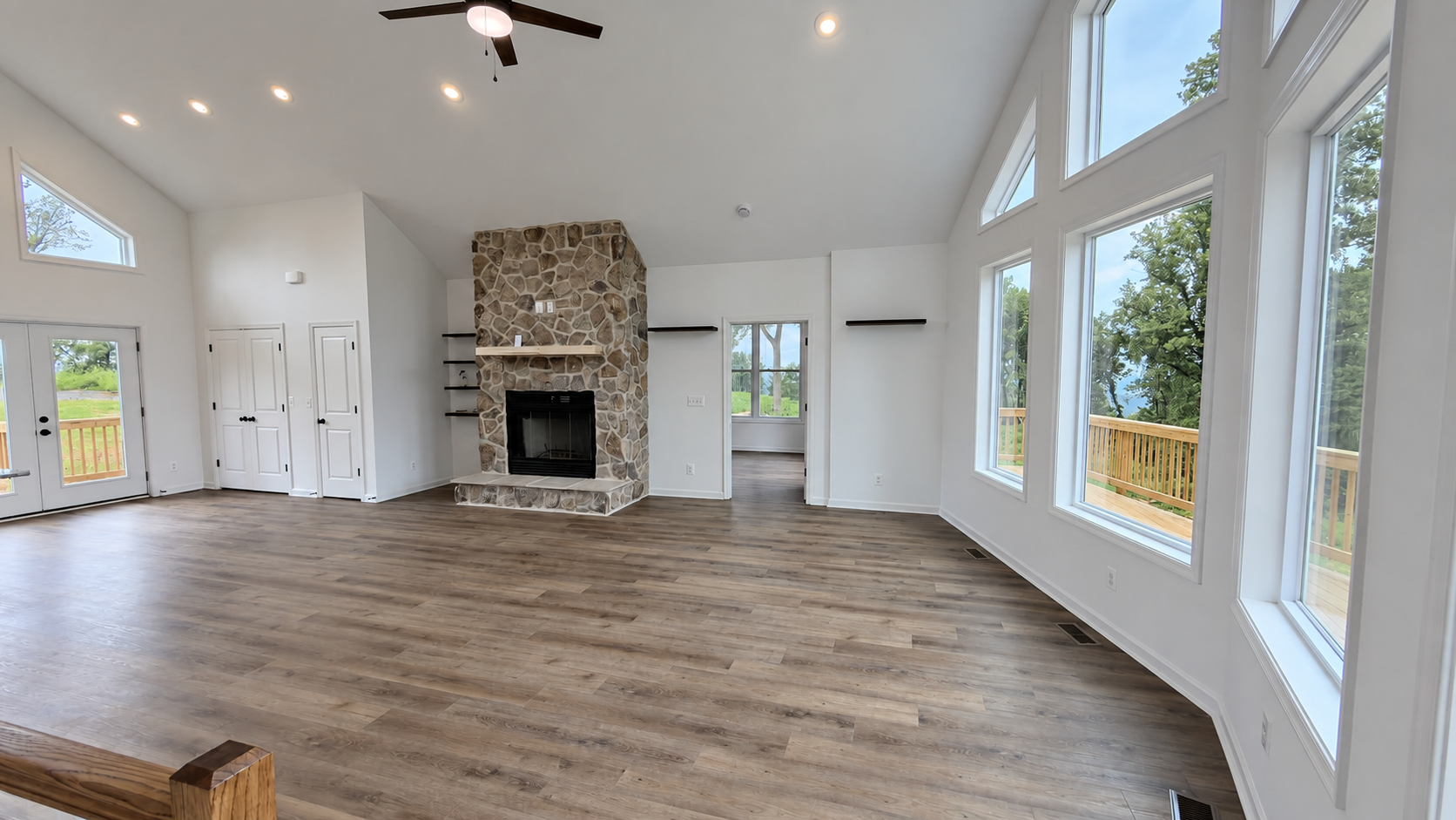 Grace Chalet great room with stone fireplace and vaulted window wall