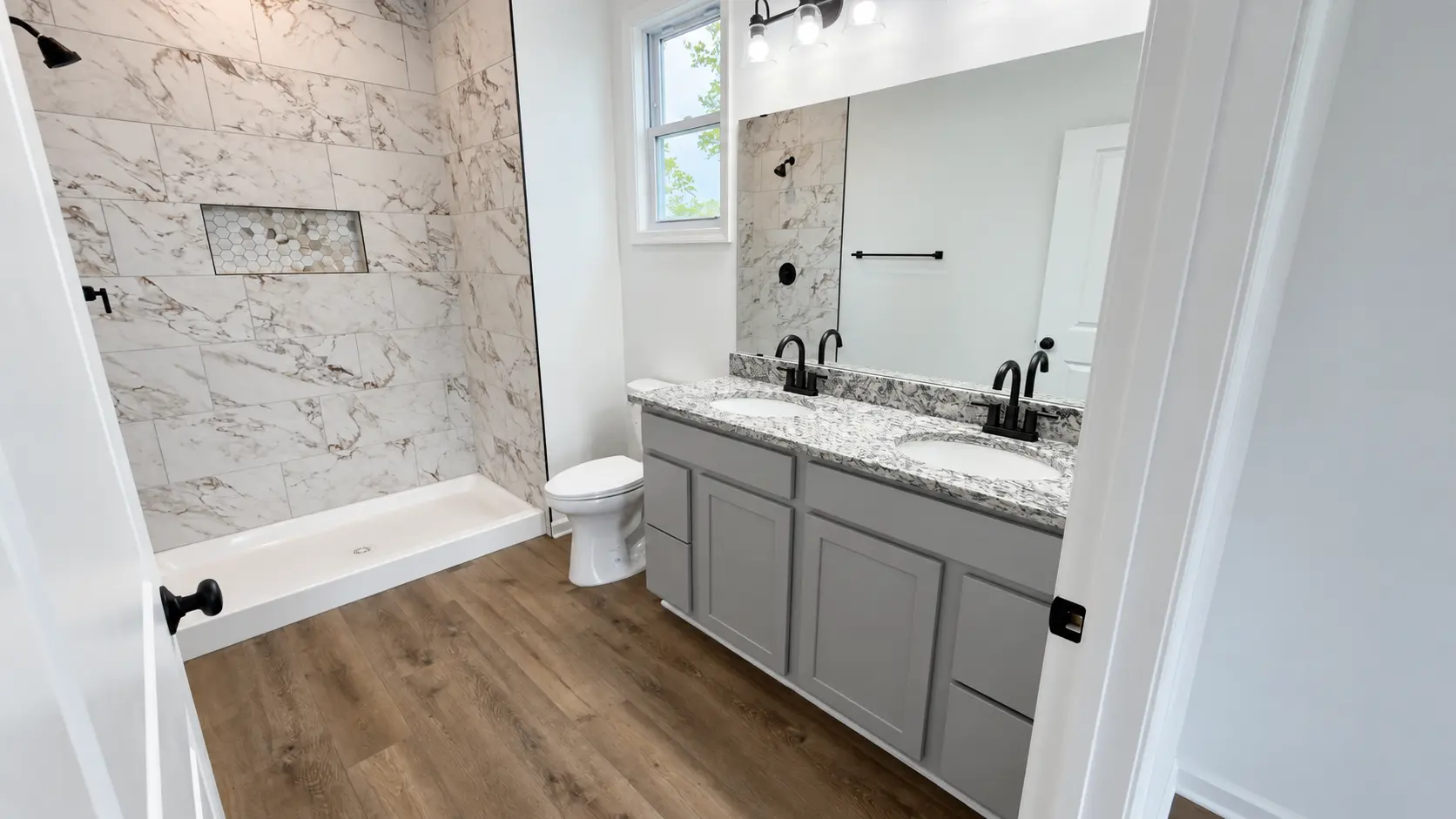Grace Chalet bathroom with tiled shower and double vanity