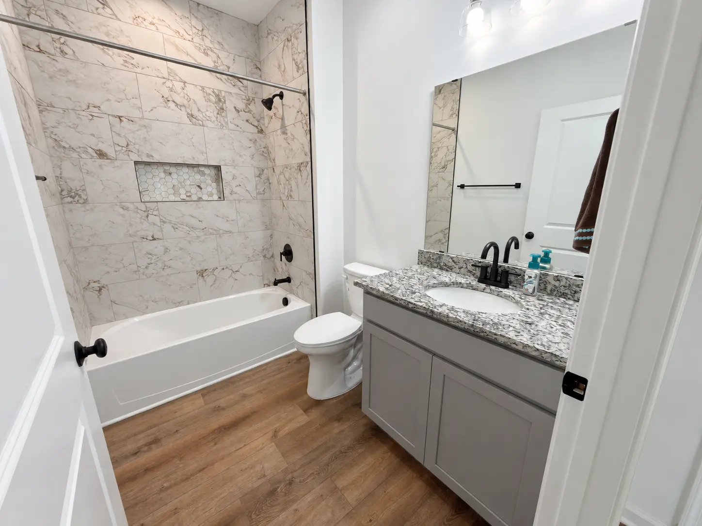 Grace Chalet bathroom with tub, tile surround, and single vanity