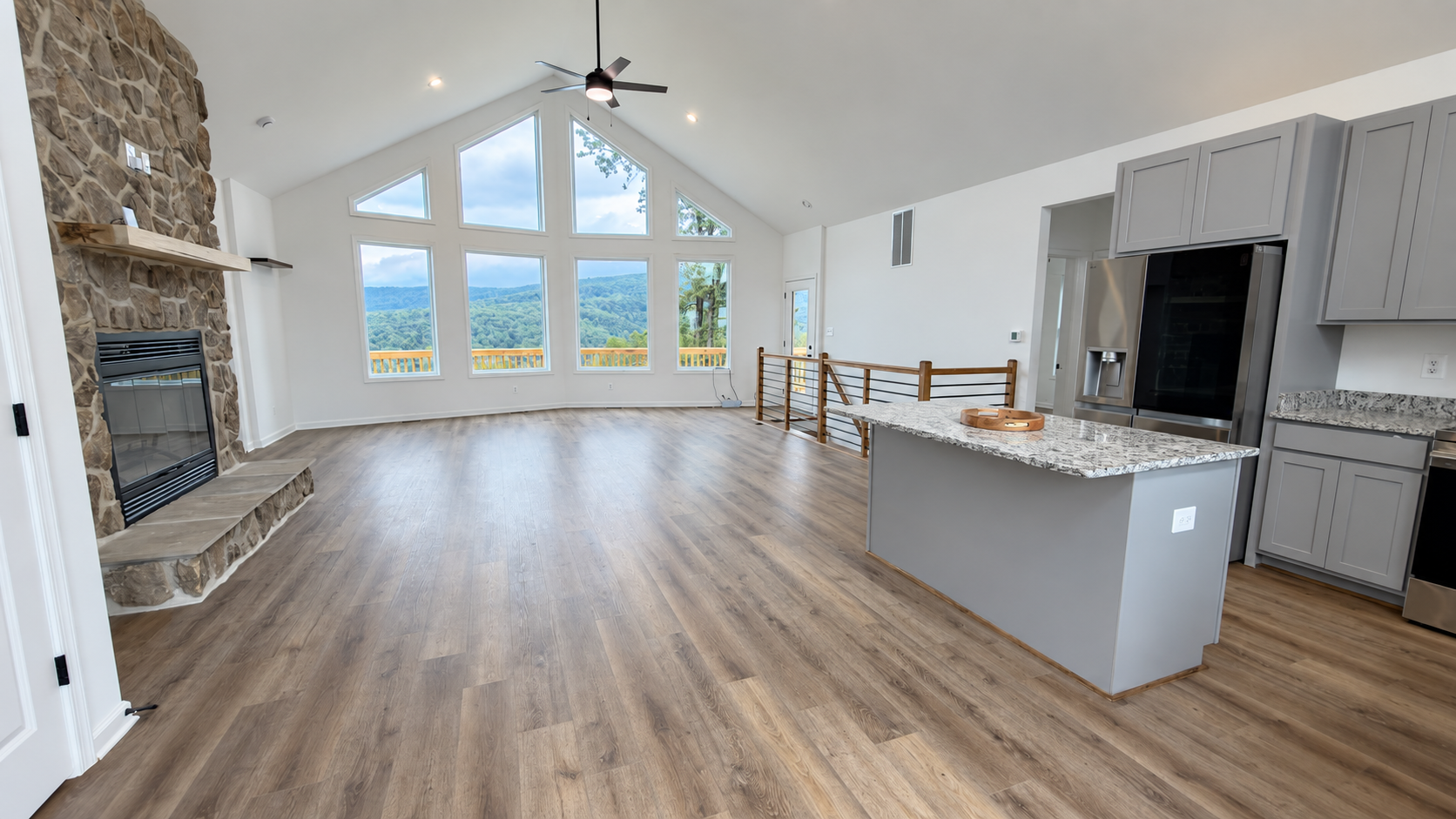 Grace Chalet great room with stone fireplace and vaulted windows