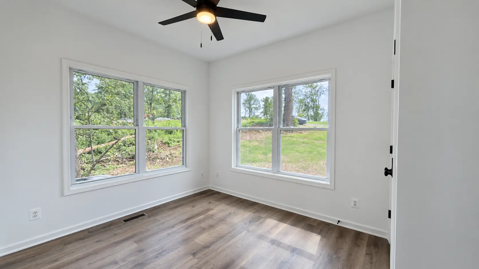 Grace Chalet bedroom with corner windows overlooking the woods